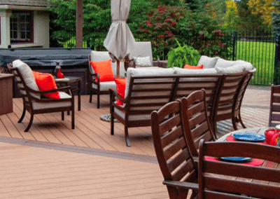 An outdoor space with vinyl decking and lots of chairs on top.